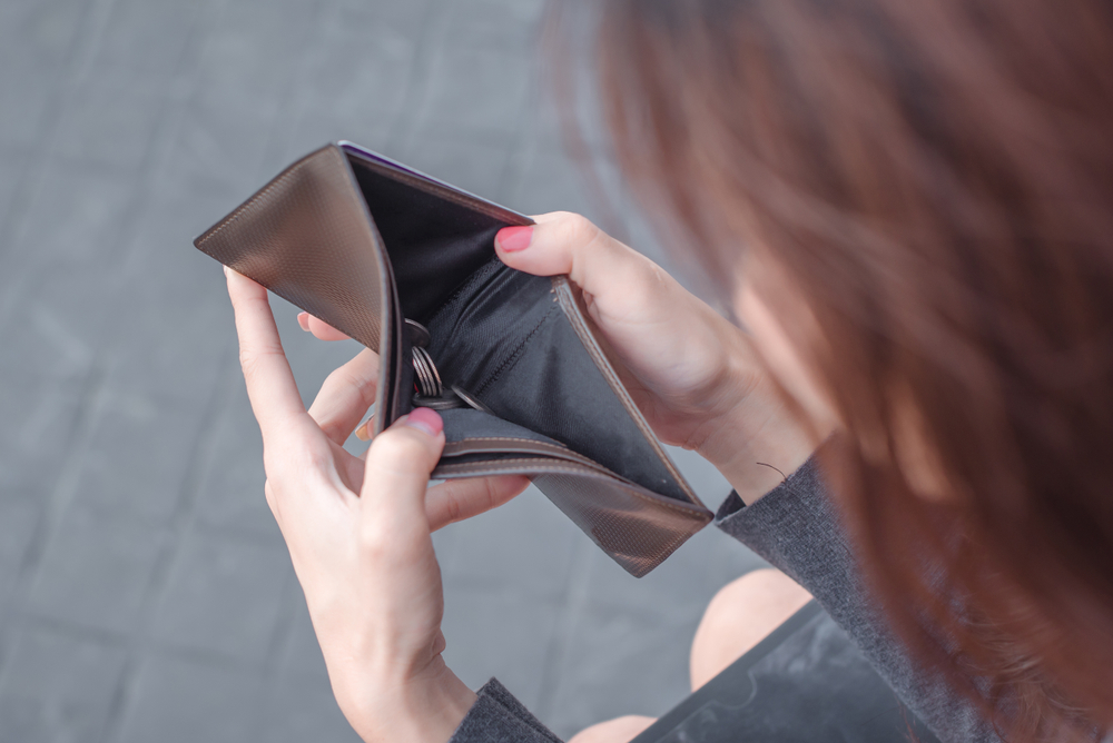 an individual holding an empty wallet