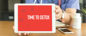 doctor holding tablet that says detox